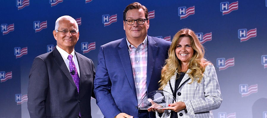 Two-men-and-a-woman-smile-and-hold-the-AHA-Quality-of-Care-Prize-winners