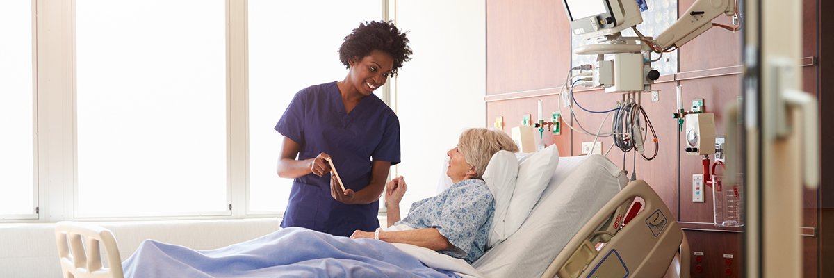 evs technician and patient in hospital bed