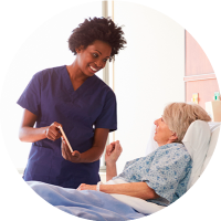 health care worked in scrubs talking with patient