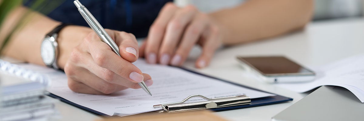 Stock photo of person with clipboard