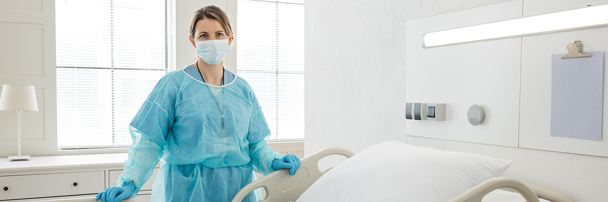 EVS woman in hospital room wearing PPE