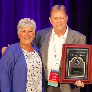 Patti Costello presenting the 2024 Phoenix Award to Rock Jensen