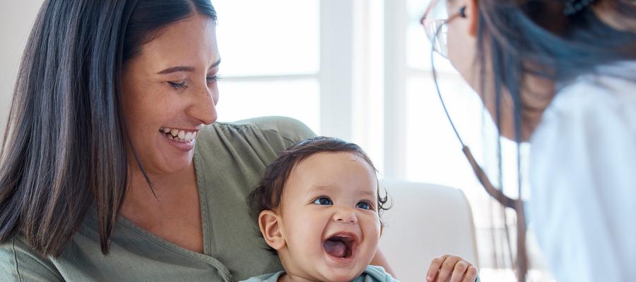 Baby smiles at doctor